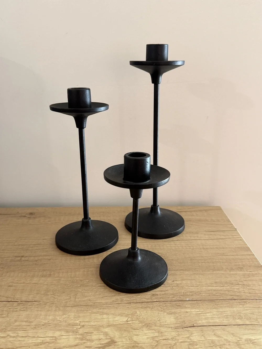 Set of three black metal taper candle holders